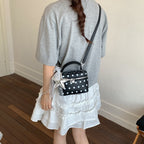 Women's mini handbag with playful design and elegant accents