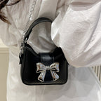Women’s mini handbag with stylish bow closure
