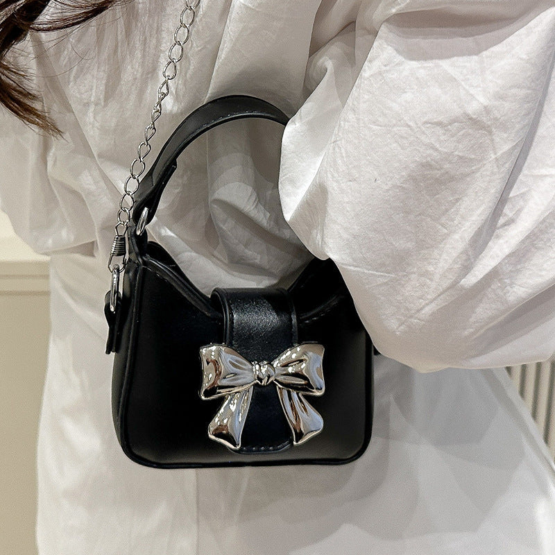 Women’s mini handbag with stylish bow closure