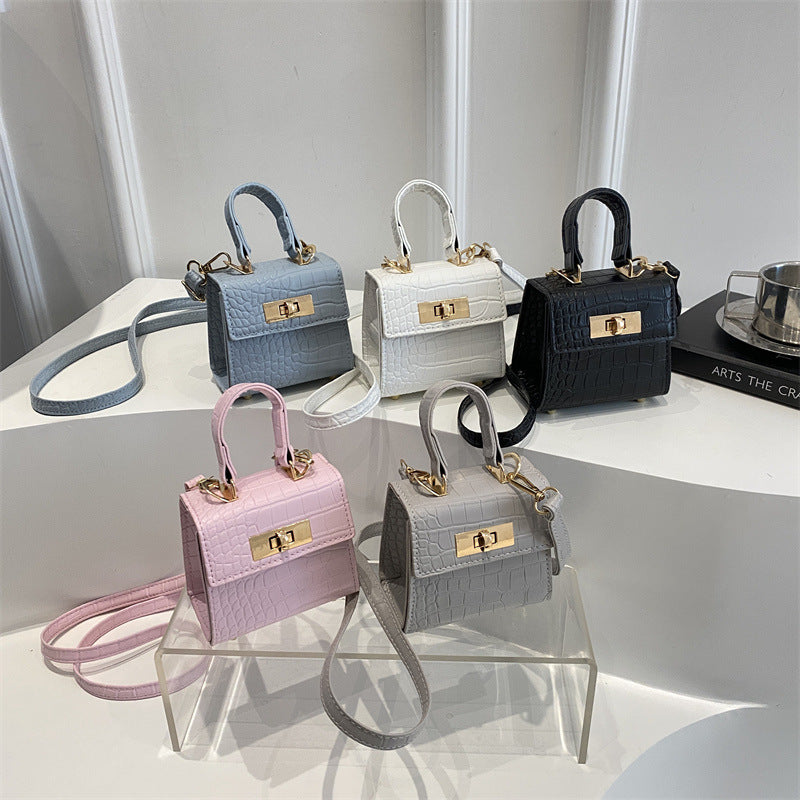 Ladies mini bag with elegant crocodile look and golden accents