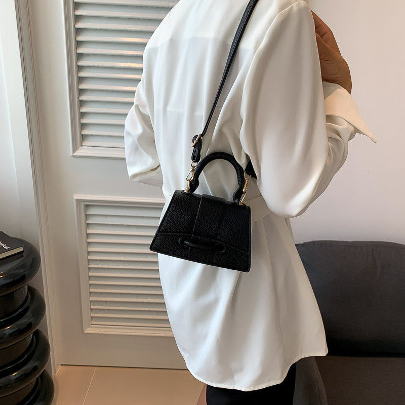 Women's mini handbag with textured leather and stylish closure