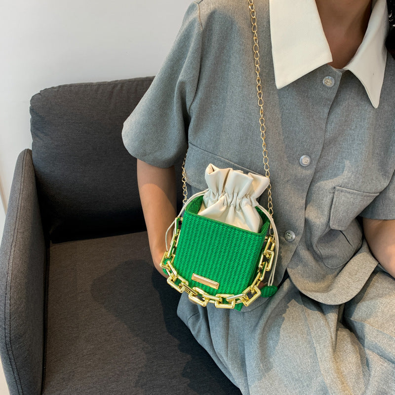 Women's mini handbag with unique chain embellishment and classic drawstring