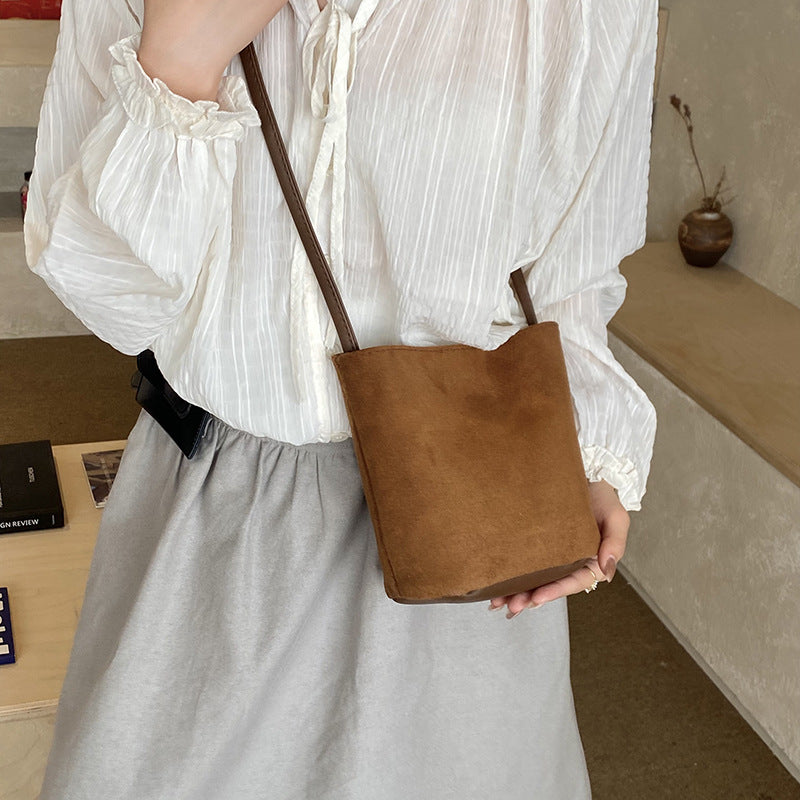Women's mini bag made of soft suede with adjustable shoulder strap