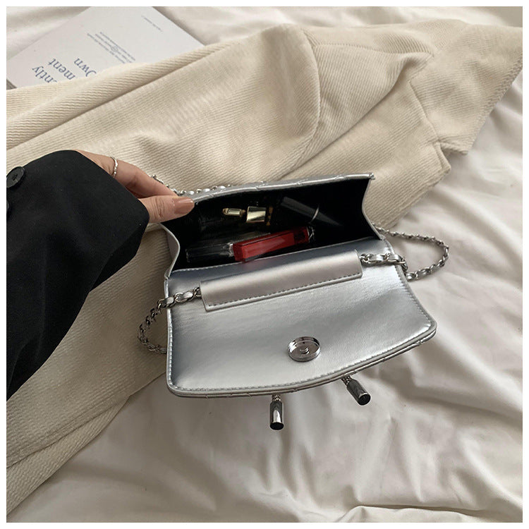 Ladies mini handbag with luxurious quilted pattern and sparkling chain pendant