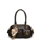 Elegant Handbag with Playful Charms and Multiple Compartments