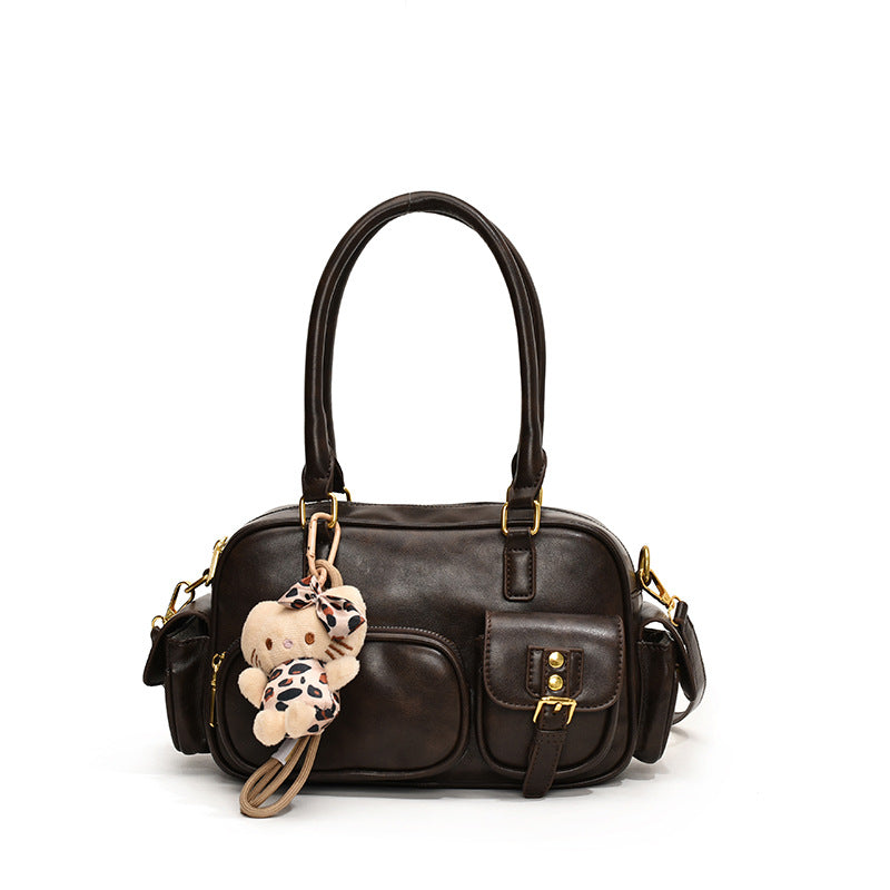 Elegant Handbag with Playful Charms and Multiple Compartments