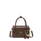 Women's mini handbag with elegant structure and charming pendant