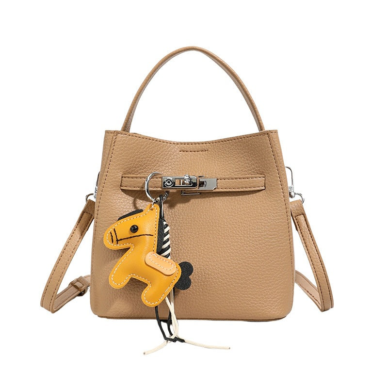 Women’s mini crossbody bag with playful design and cute charm