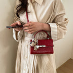 Women's mini crossbody bag with playful charm