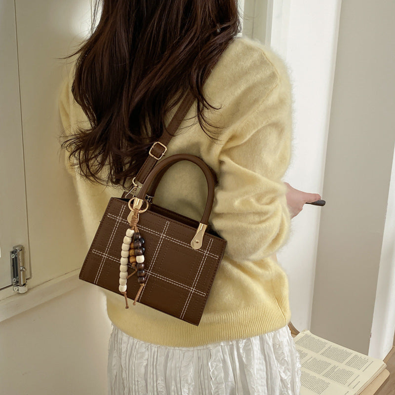 Women's mini handbag with elegant structure and golden accents