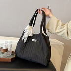 Leisure bag with structured design and playful scarf