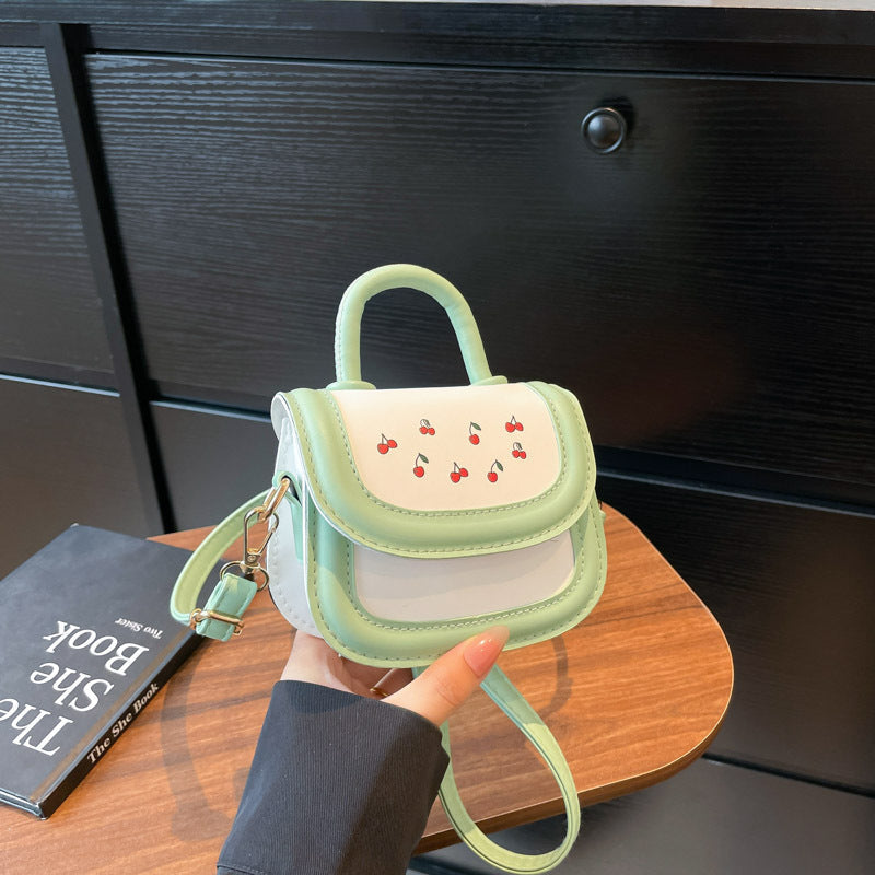Women's mini handbag with cheerful cherry design and charming pendants