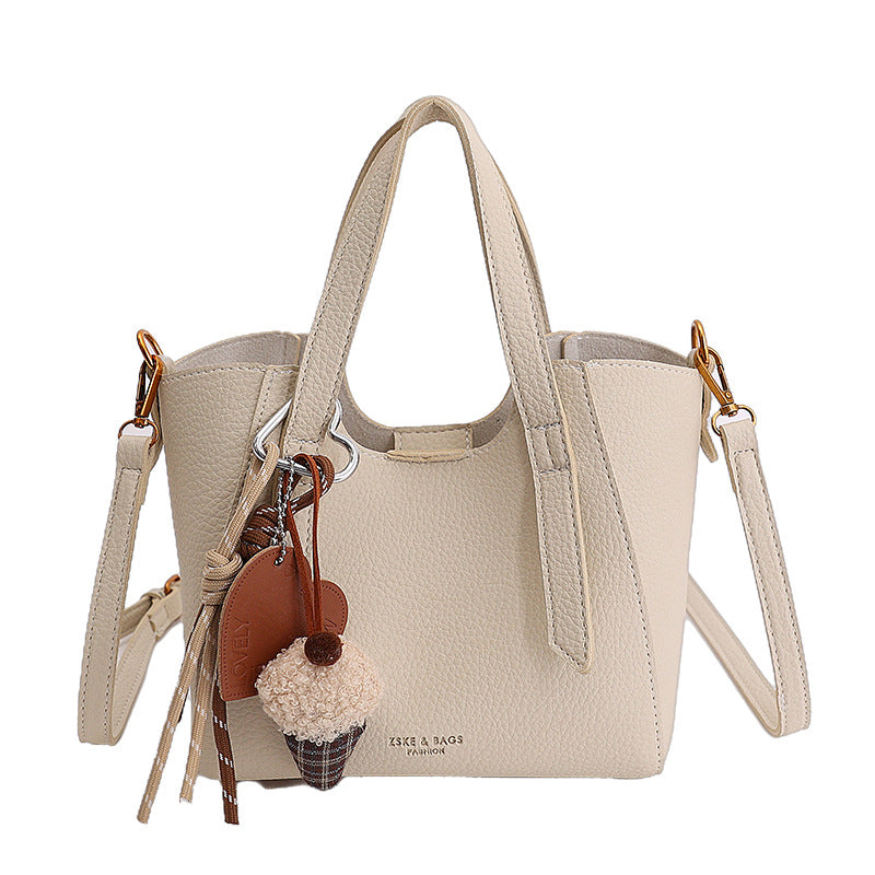 Women's mini handbag in an elegant design with charming pendant