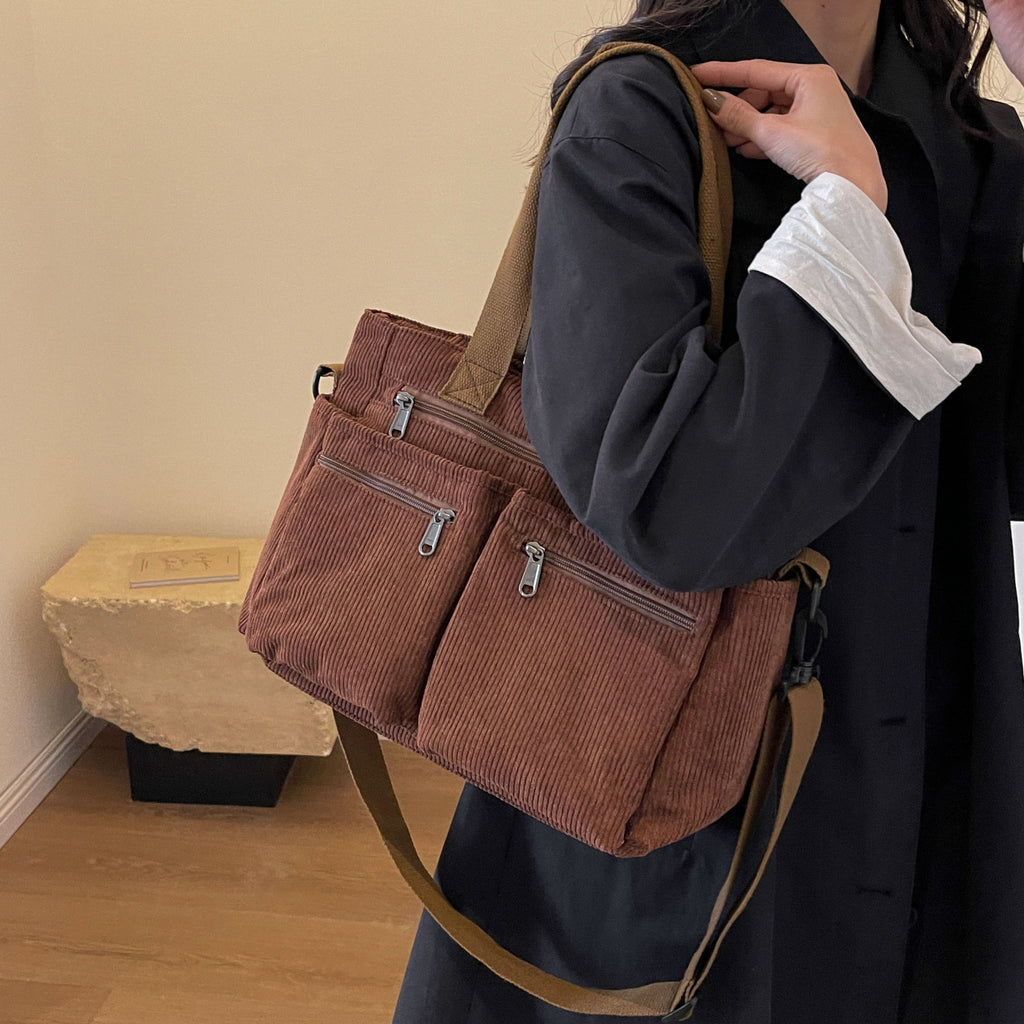 Durable shoulder bag with multiple compartments