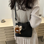 Women’s mini bag with playful animal pendant