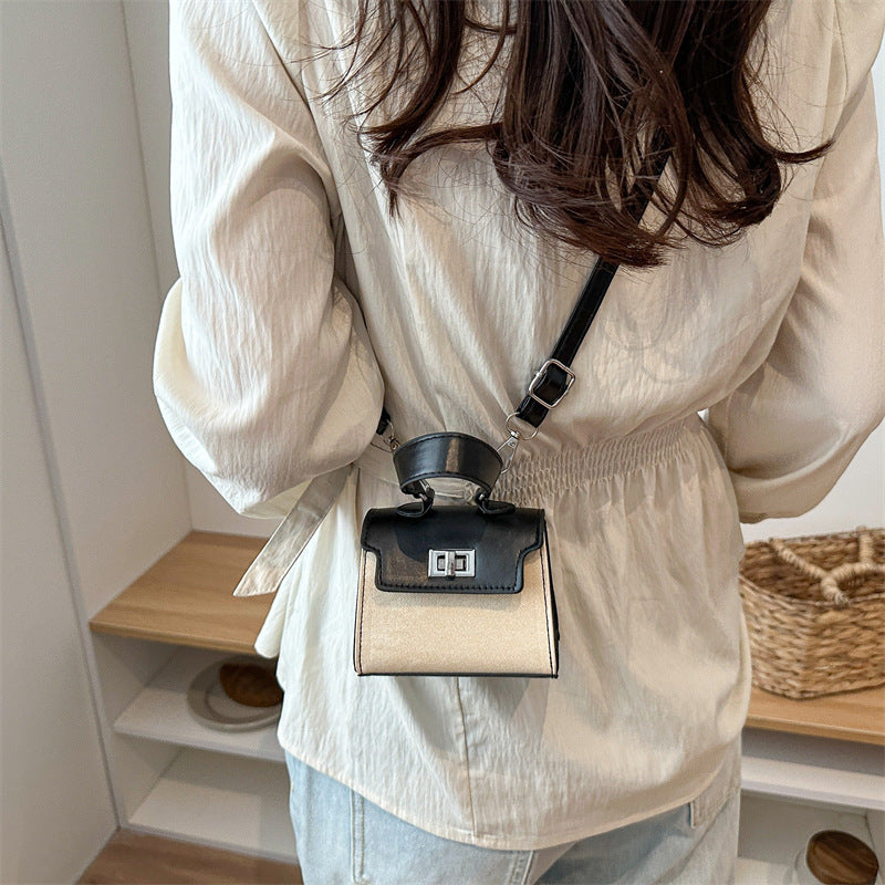 Ladies mini handbag with luxurious leather look and practical carrying handles