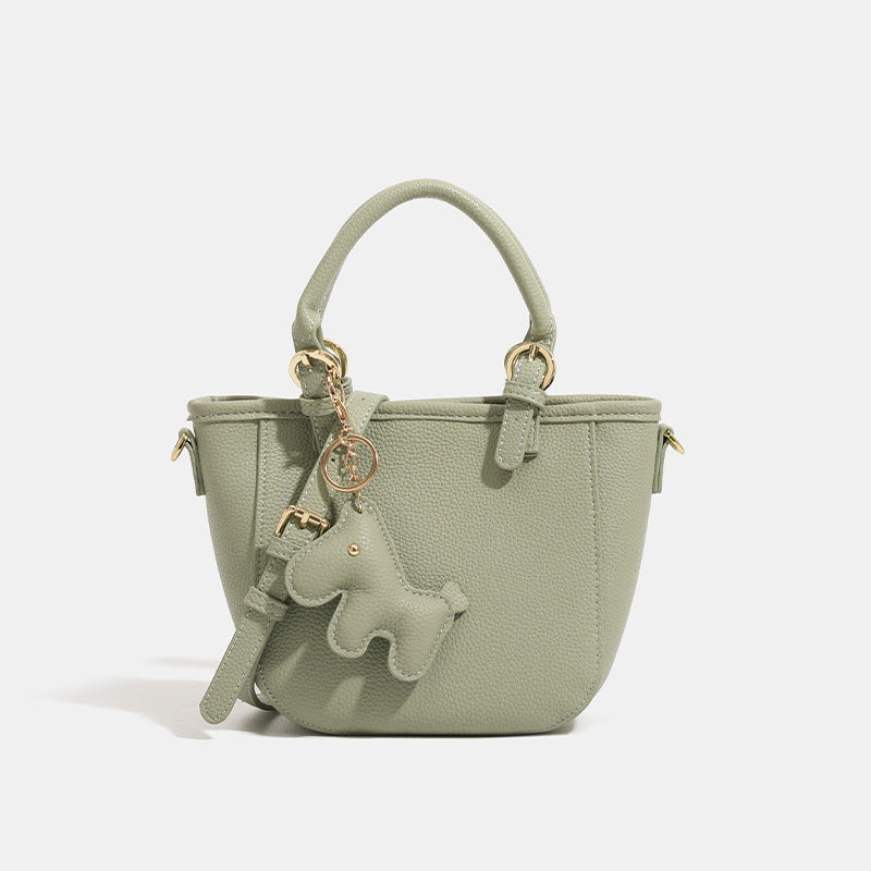 Women's mini handbag with playful animal charm
