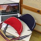 Fashionable shoulder bag with unique cut and adjustable strap