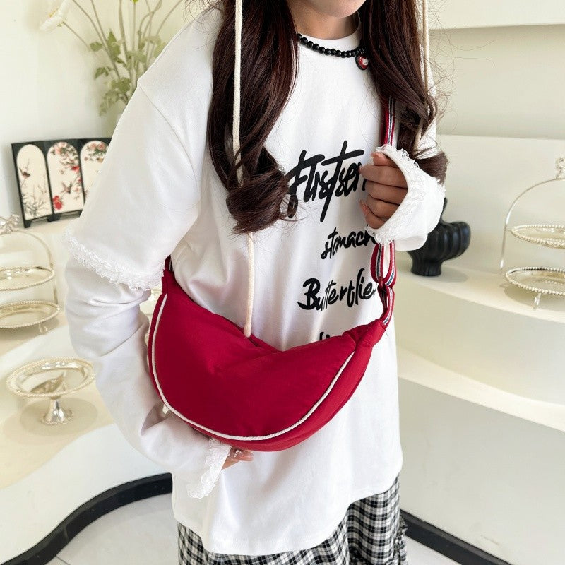 Fashionable shoulder bag with unique cut and adjustable strap