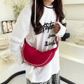 Fashionable shoulder bag with unique cut and adjustable strap
