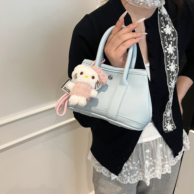Women’s mini handbag with playful plush pendant