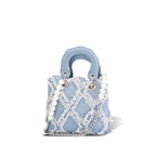 Women’s mini handbag with striking cinched design and pearl accents