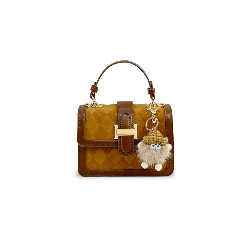 Women’s mini handbag with decorative braided pattern and playful pendant