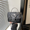 Ladies mini handbag with decorative quilting and playful cat motif
