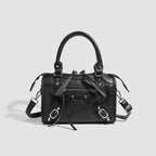 Women's mini handbag with decorative metal accents and removable shoulder strap