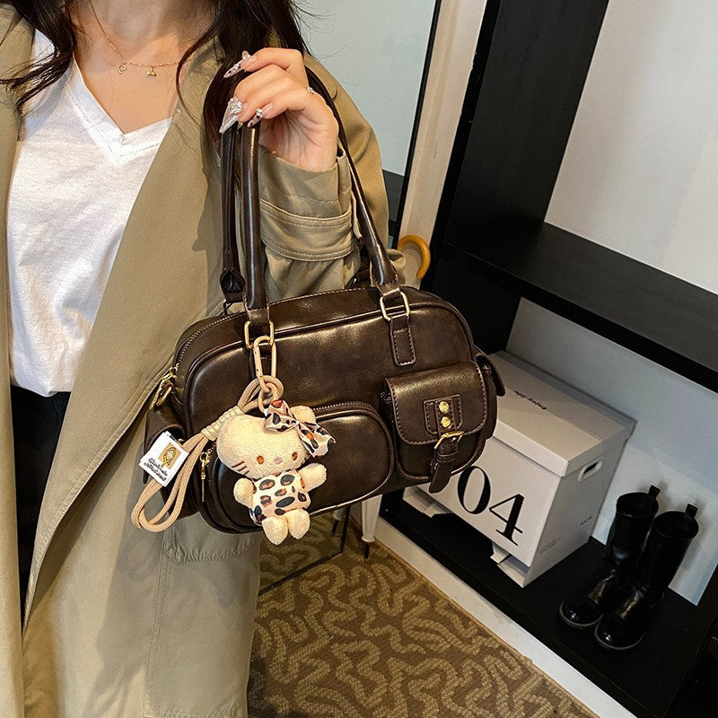 Elegant Handbag with Playful Charms and Multiple Compartments