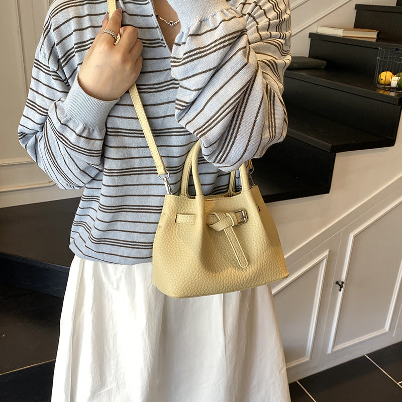 Women's mini handbag with stylish button closure