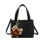 Women’s mini bag with playful animal pendant