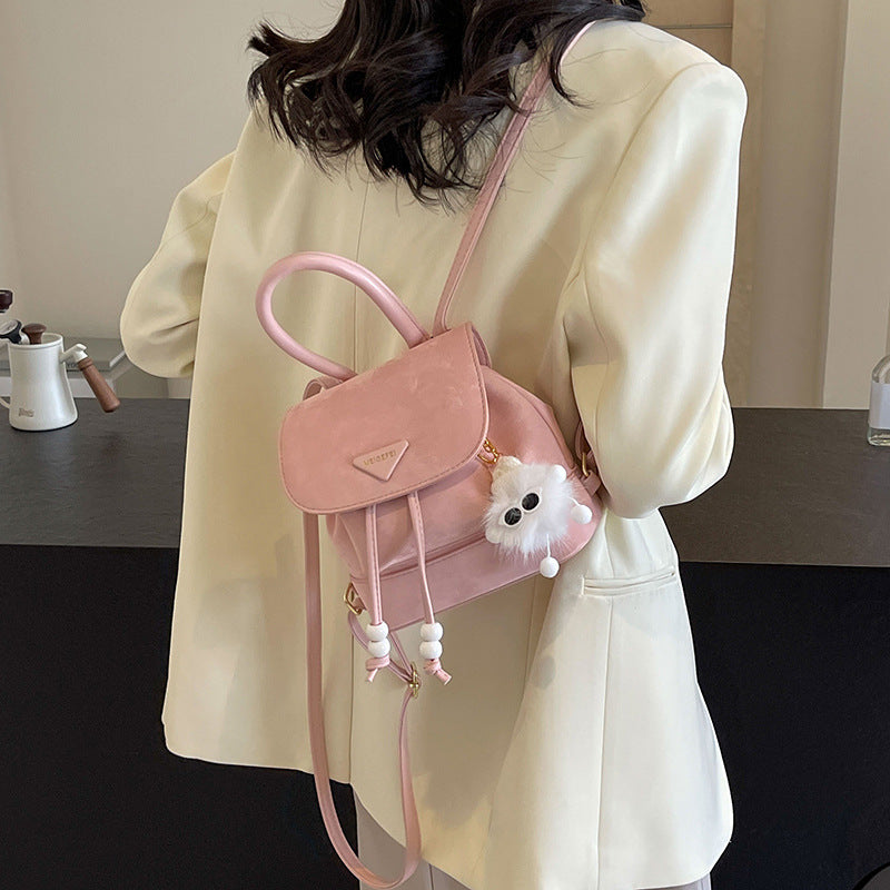 Women's mini backpack with playful design and plush pendant
