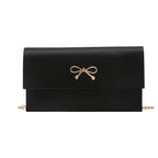 Women's elegant clutch in minimalist design with golden accents
