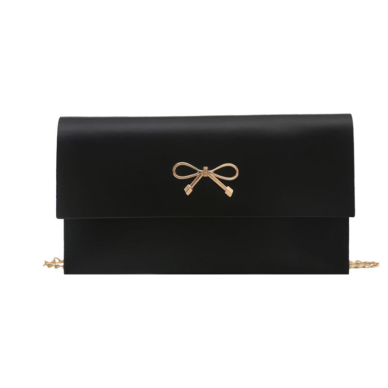 Women's elegant clutch in minimalist design with golden accents