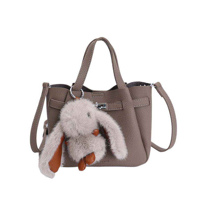 Women's mini handbag with playful design and animal charm