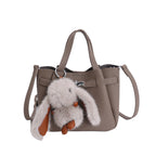 Women's mini handbag with playful design and animal charm
