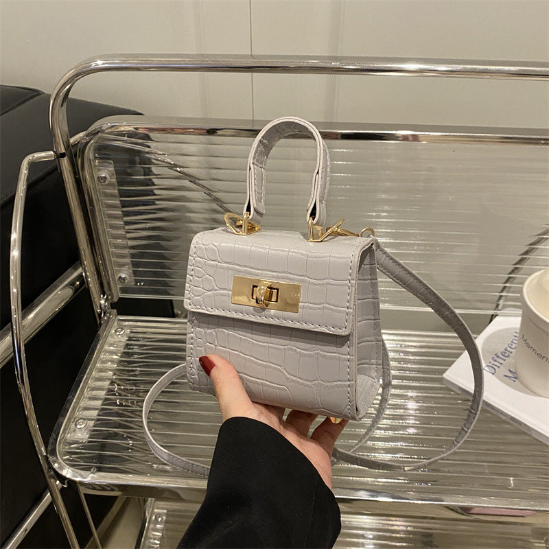 Ladies mini bag with elegant crocodile look and golden accents