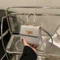 Ladies mini bag with elegant crocodile look and golden accents