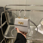 Ladies mini bag with elegant crocodile look and golden accents