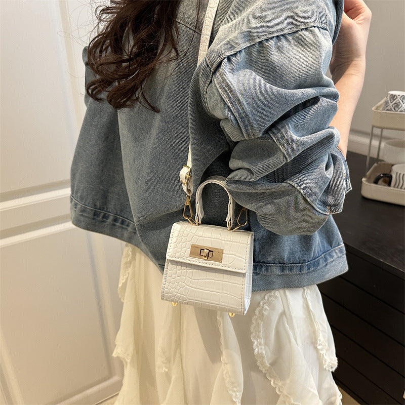 Ladies mini bag with elegant crocodile look and golden accents