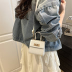 Ladies mini bag with elegant crocodile look and golden accents