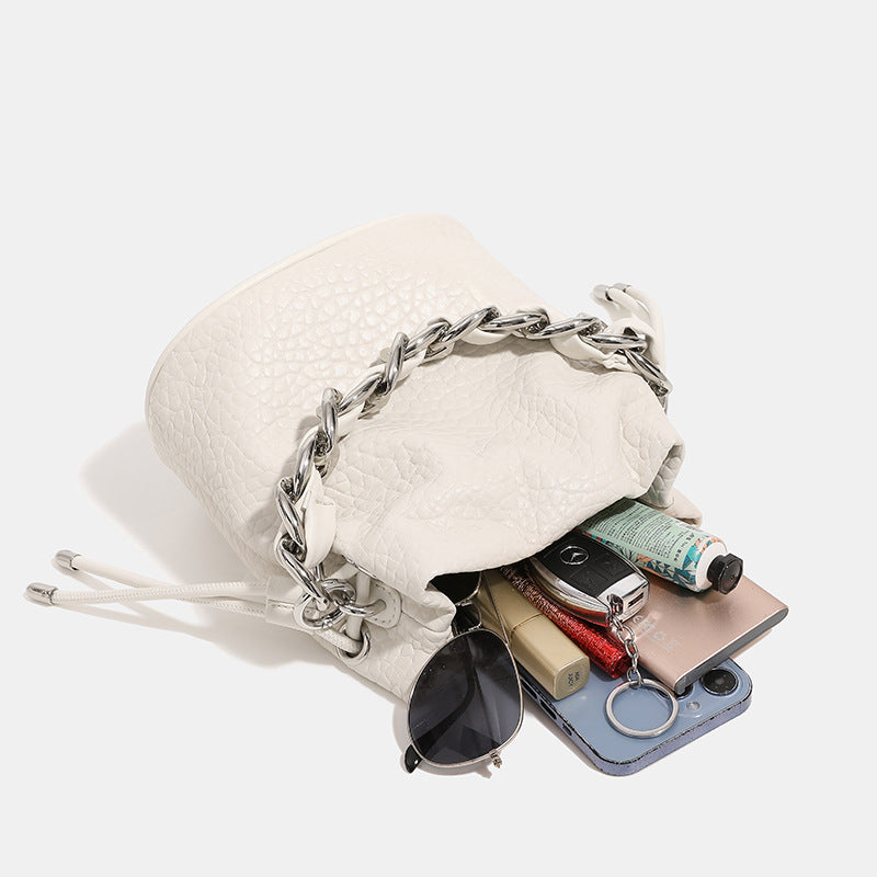 Women's mini backpack bag with elegant chain handle and fine texture