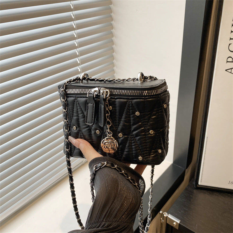 Women's mini handbag with elegant quilting and chain pendant
