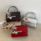 Women's mini crossbody bag with playful charm