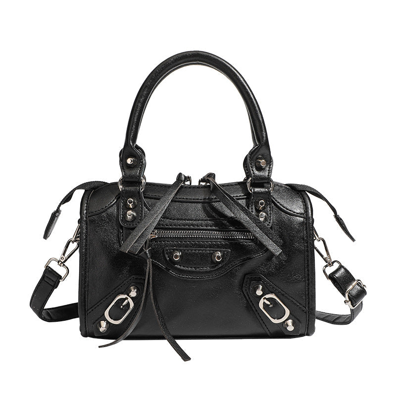 Women's mini handbag with decorative metal accents and removable shoulder strap
