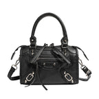 Women's mini handbag with decorative metal accents and removable shoulder strap
