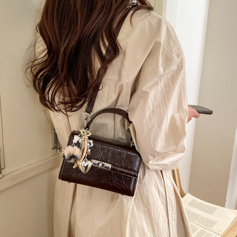 Women's mini crossbody bag with playful charm