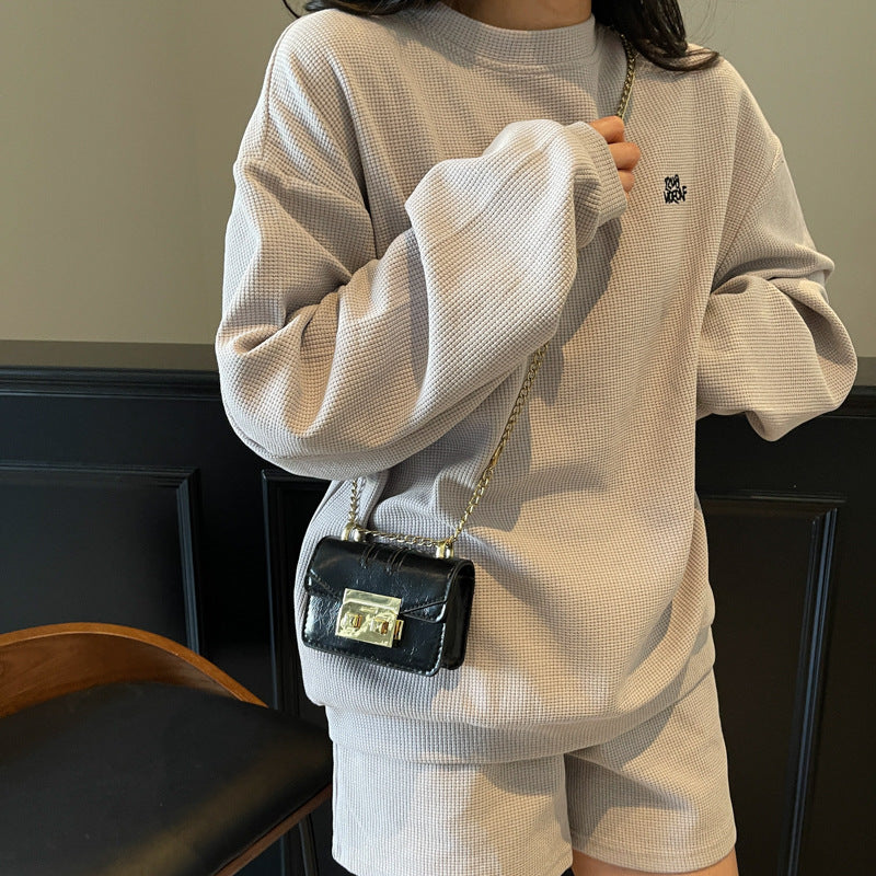 Women's elegant mini handbag with gold fastening mechanism