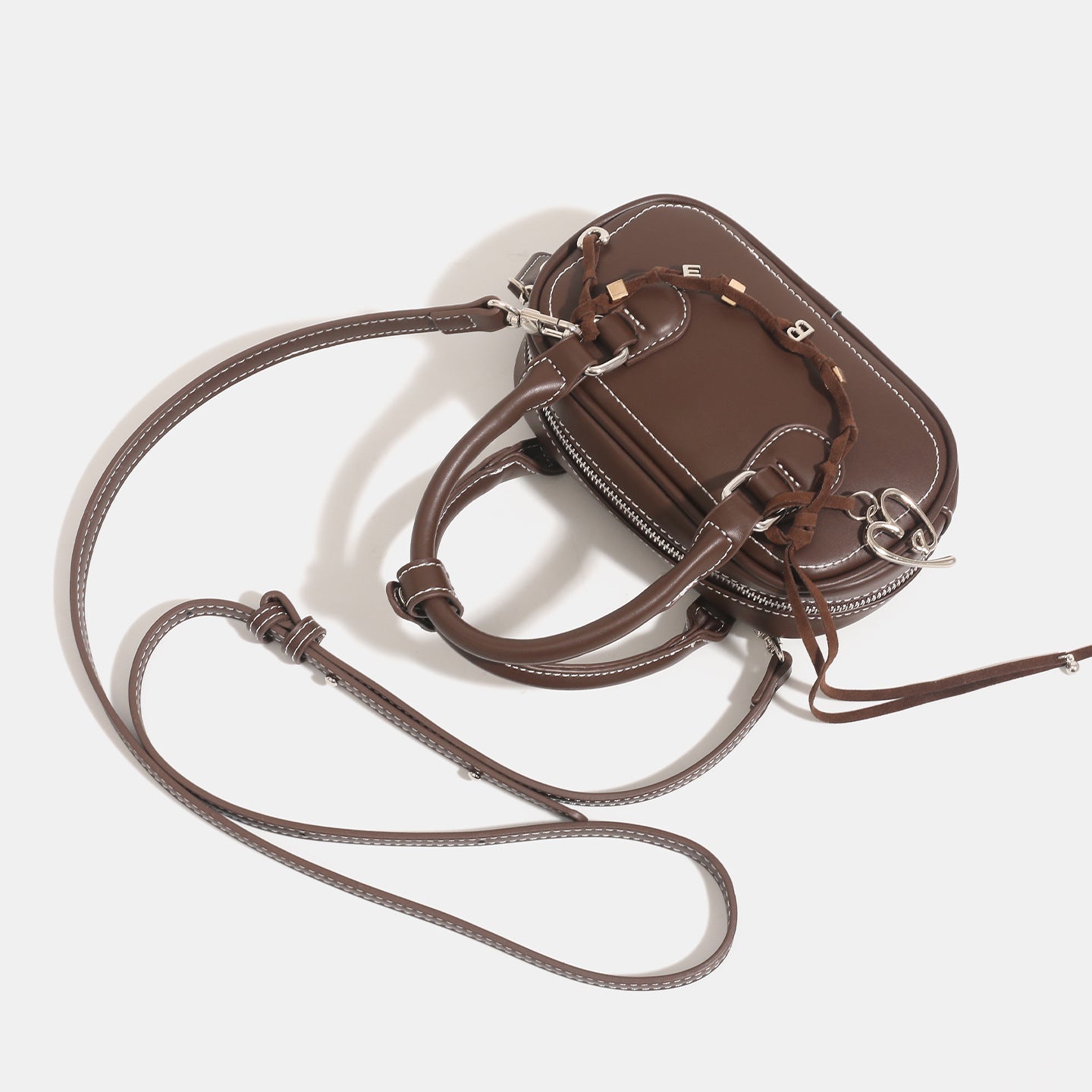Women's mini handbag with playful drawstring and elegant accents